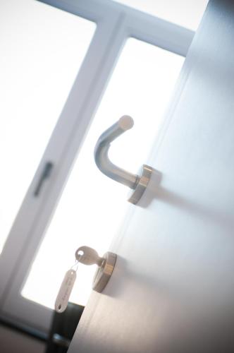 a pair of handcuffs hanging from a window at Apartment De Maasnacht in Maaseik