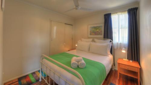 a bedroom with a bed with two towels on it at Village Stays Coldstream Gallery Apartment in Ulmarra