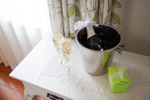 a bottle of wine in a bucket on a table at Tairoa Lodge in Hawera