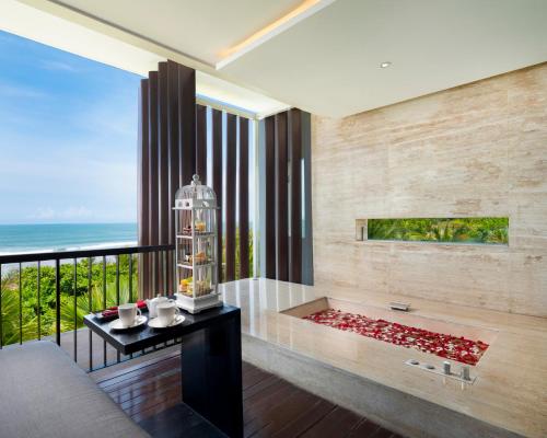 a living room with a view of the ocean at Grand Seminyak Lifestyle Boutique Bali Resort in Seminyak