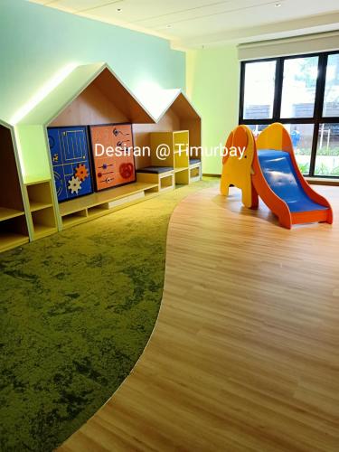 a childrens play room with a slide at Desiran @ Timurbay - seafront studio apartment with WiFi in Kuantan