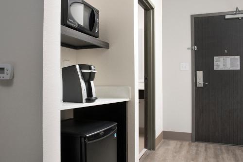 a small room with a tv and a trash can at Holiday Inn Express Pensacola Downtown by IHG in Pensacola