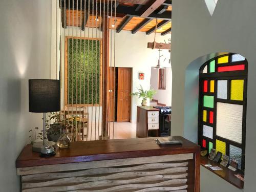 a room with a desk and stained glass windows at Hotel Casa Azabache in San Cristóbal de Las Casas