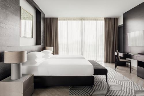 a hotel room with a bed and a desk at The Pavilions Phuket in Bang Tao Beach