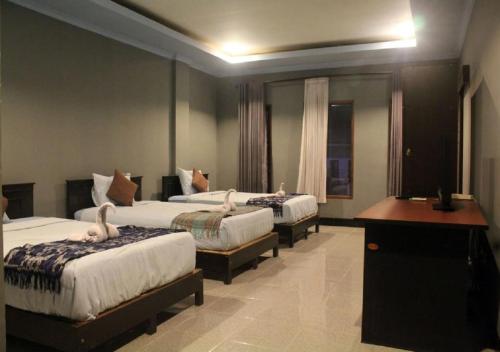 Postel nebo postele na pokoji v ubytování Ridho Malik Hotel