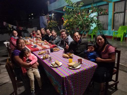 a large group of people sitting at a table at Casa Guillermo Batz in San Pedro La Laguna