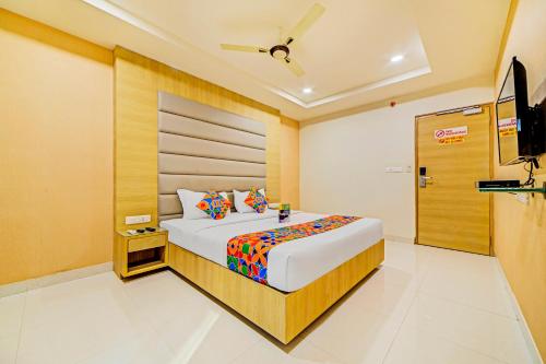 a hotel room with a bed and a television at FabHotel Viraj Suites Gachibowli in Hyderabad