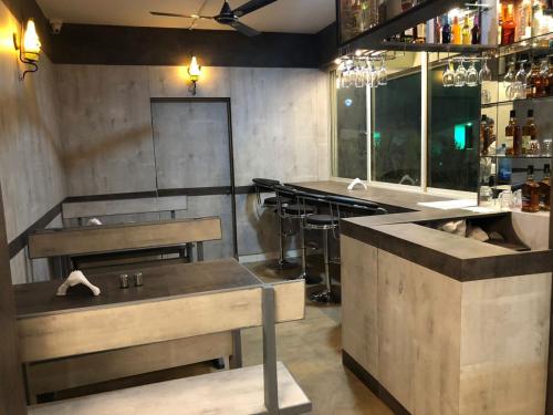 a kitchen with two sinks and a bar in a restaurant at Kay's Riverview Resort in Baga