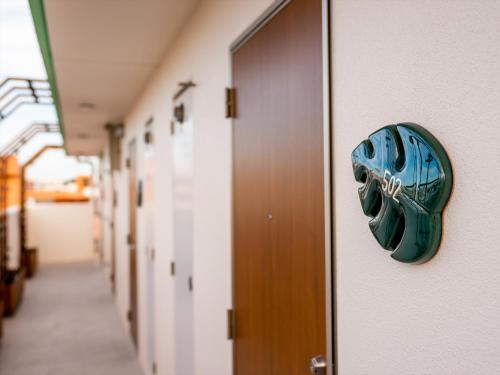 a blue glove is on the door of a hallway at The Moana by DSH Resorts in Chatan