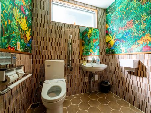 a bathroom with a toilet and a sink at The Moana by DSH Resorts in Chatan