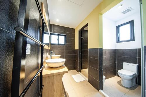 a bathroom with a sink and a toilet at 澎湖 就這兒旅居 in Magong