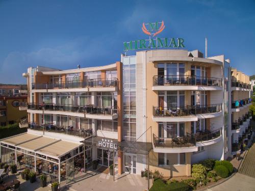 a hotel with a sign on top of it at Hotel Miramar Sozopol in Sozopol