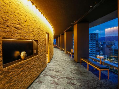 a corridor of a building with a view of a city at Hotel Honnoji in Kyoto