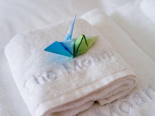 a paper boat sitting on top of towels at The Moana by DSH Resorts in Chatan