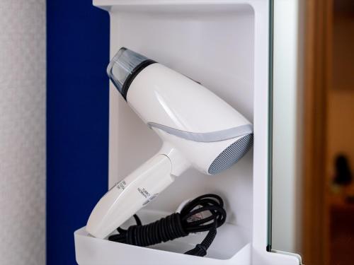 a hair dryer in a white box with a cord at The Moana by DSH Resorts in Chatan