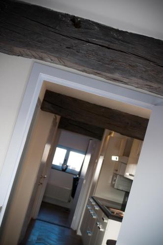 an open doorway to a kitchen with a window at Apartment De Maasnacht in Maaseik
