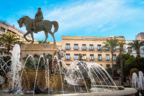 a statue of a man on a horse in front of a fountain at Apartamentos Arenal in Jerez de la Frontera