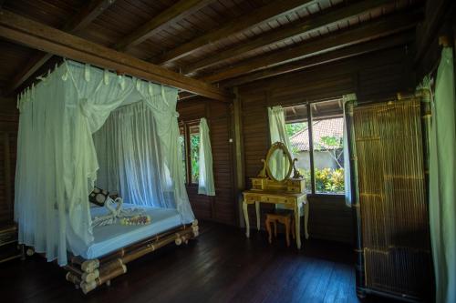 
a bedroom with a bed and a canopy at Villa Uma Ayu Sidemen in Sidemen
