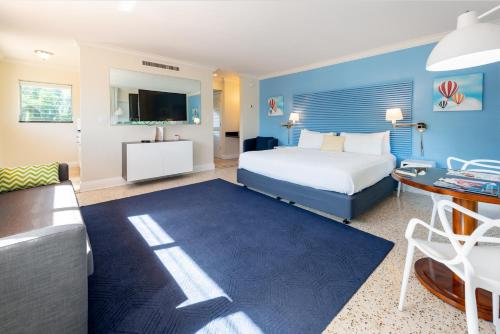 a hotel room with a bed and a desk at Victoria Park Hotel in Fort Lauderdale