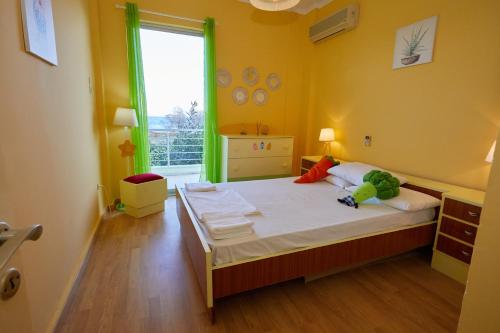 a bedroom with a bed with two stuffed animals on it at Karfas sea view apartment in Karfas