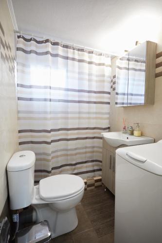 a bathroom with a toilet and a sink at Karfas sea view apartment in Karfas