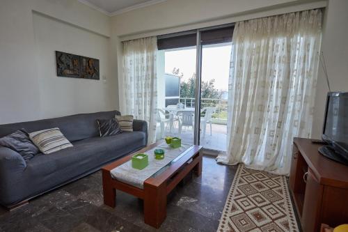 a living room with a couch and a coffee table at Karfas sea view apartment in Karfas