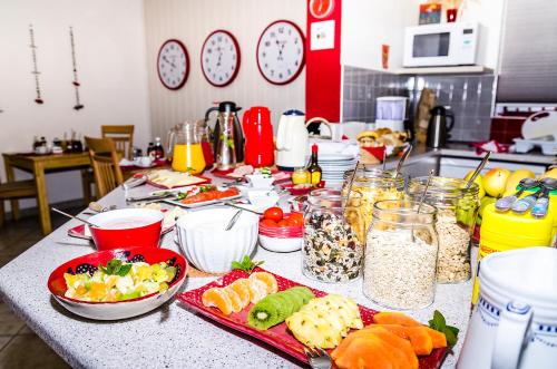 a table with plates of food and bowls of food at Meike's Guesthouse in Swakopmund