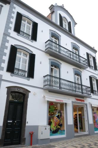 a white building with black windows and balconies at Edificio Charles 202 in Funchal