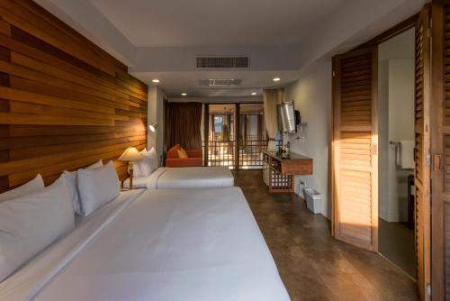 Säng eller sängar i ett rum på Nanda Heritage Hotel