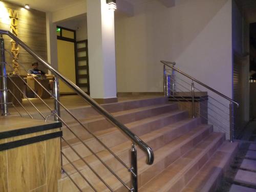 a person sitting on the stairs of a building at The Monalysa Suites & Residence in Grand Baie