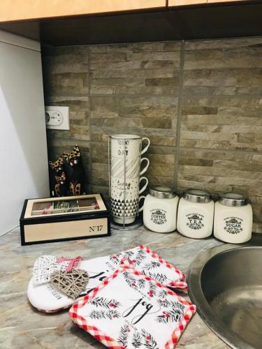 a kitchen counter with a sink and a counter top with towels at Apartman Jela in Nova Varoš