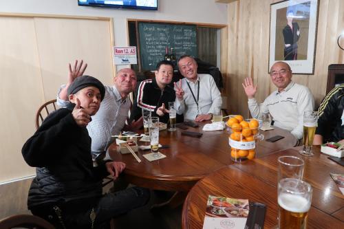 a group of men sitting around a table in a restaurant at B&B MIKAWA 2 - Kanazawa Fish Harbour in Kanazawa