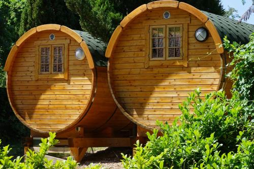 a small wooden hobbit house with two windows at Barrel -schlafen im Fass in Gorleben