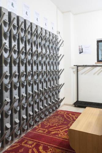 a wall of knives in a room with a table at VillaGiardino - Lake in Molveno