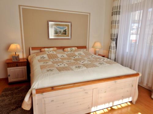 a bedroom with a large bed with a wooden frame at Villa Minna in Göhren