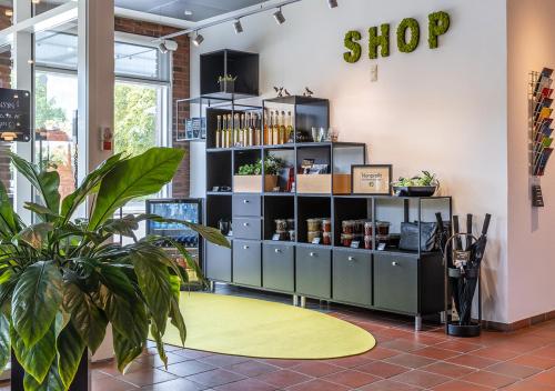 a shop with a yellow rug in a room at Pharmakon Hotel & Conferencecenter in Hillerød