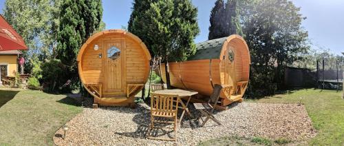a couple of wooden boats on display in a yard at Barrel -schlafen im Fass in Gorleben
