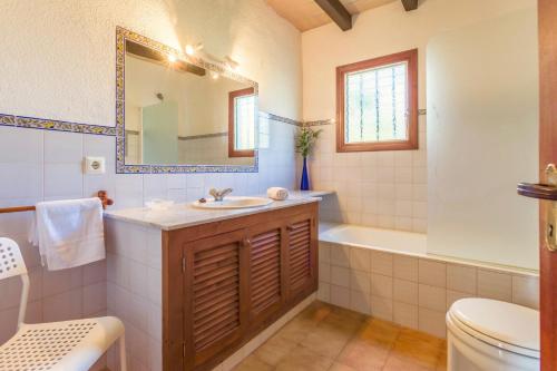 a bathroom with a sink and a tub and a toilet at Villa Totxa in Pollença