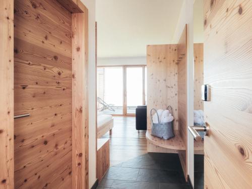 a room with wooden walls and a hallway with a door at Alpinhotel Pacheiner in Treffen