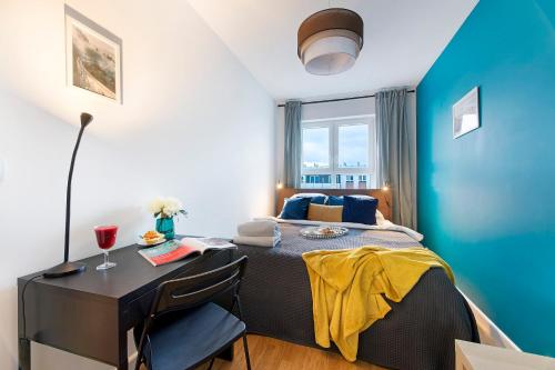 a bedroom with a bed and a desk and a window at Warszawa Zachodnia Station Serviced Apartments in Warsaw