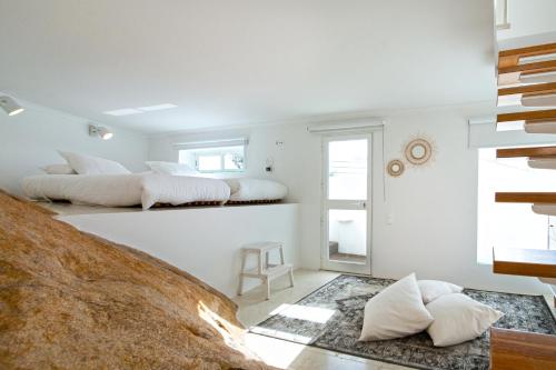 two beds in a room with white walls at Sea View Cascais Design Villa in Alcabideche