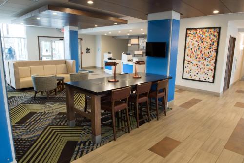 a conference room with a table and chairs and a couch at Holiday Inn Express & Suites - Orland Park Mokena by IHG in Mokena