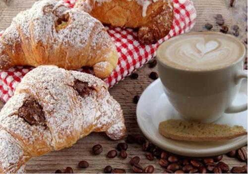 een tafel met gebak en een kopje koffie bij B&B Lemon Flats in Napels