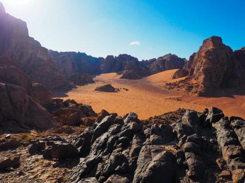a view of the desert with rocks and mountains at Bedouin host camp& with tour in Wadi Rum