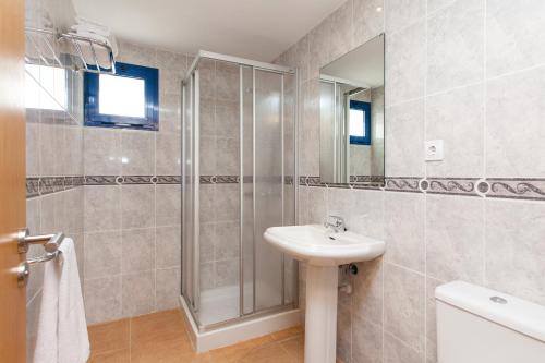 a bathroom with a shower and a sink at TAO El Cotillo in El Cotillo