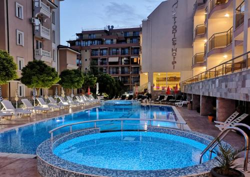 a large swimming pool in the middle of a building at Tropics Hotel - Ultra All Inclusive in Sveti Vlas
