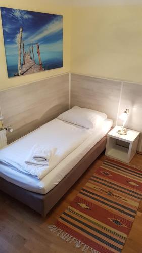 a bedroom with a bed and a table with a lamp at Gästehaus Schmitt in Erlangen