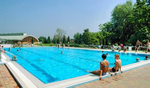 a group of people sitting in a swimming pool at Don Quijote Középkori Panzio és Étterem in Lenti