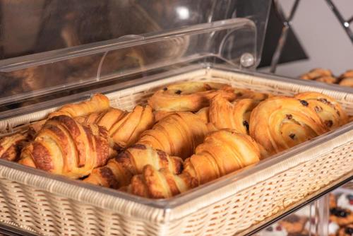 a bunch of pastries in a basket in a bakery at ZENTRUM Hotel in Chişinău
