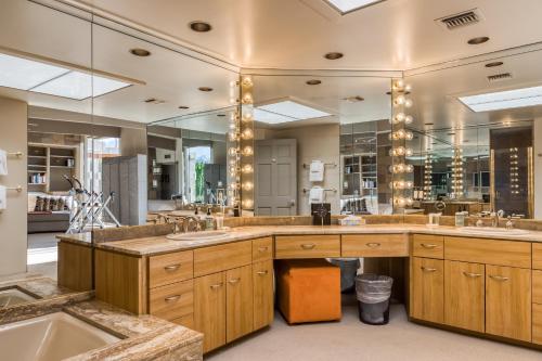 a large bathroom with two sinks and a large mirror at Morning Springs Mirage in Rancho Mirage